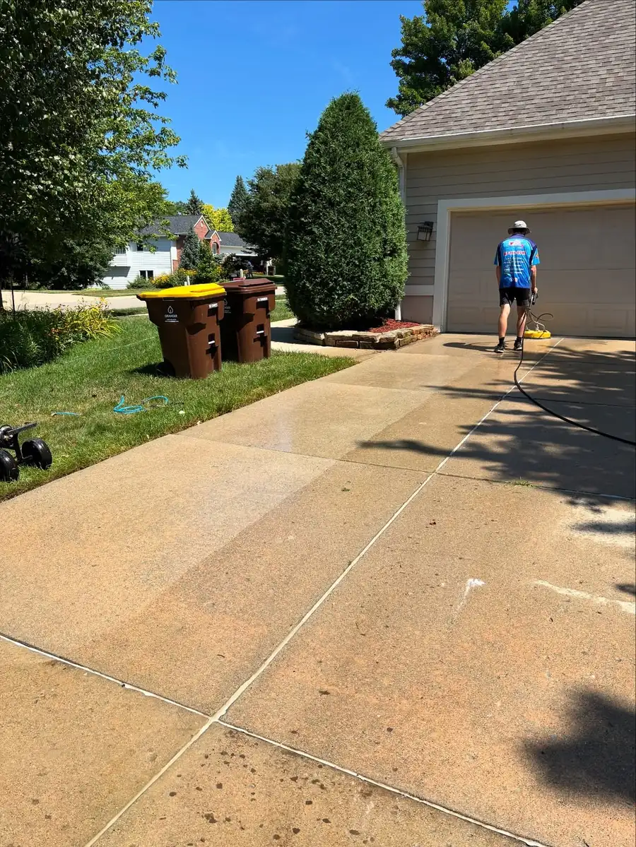 Scheduled driveway cleaning service at a home in Okemos, MI
