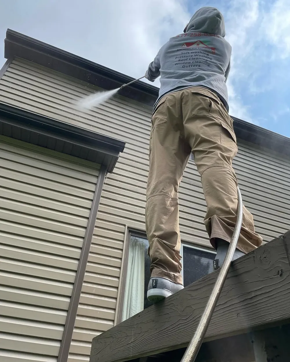Gutter cleaning service at a home in Okemos, MI