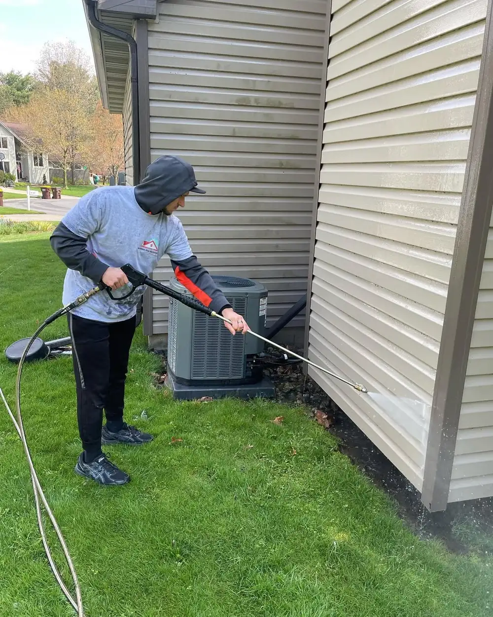 House washing service softly cleaning siding in Dewitt, MI
