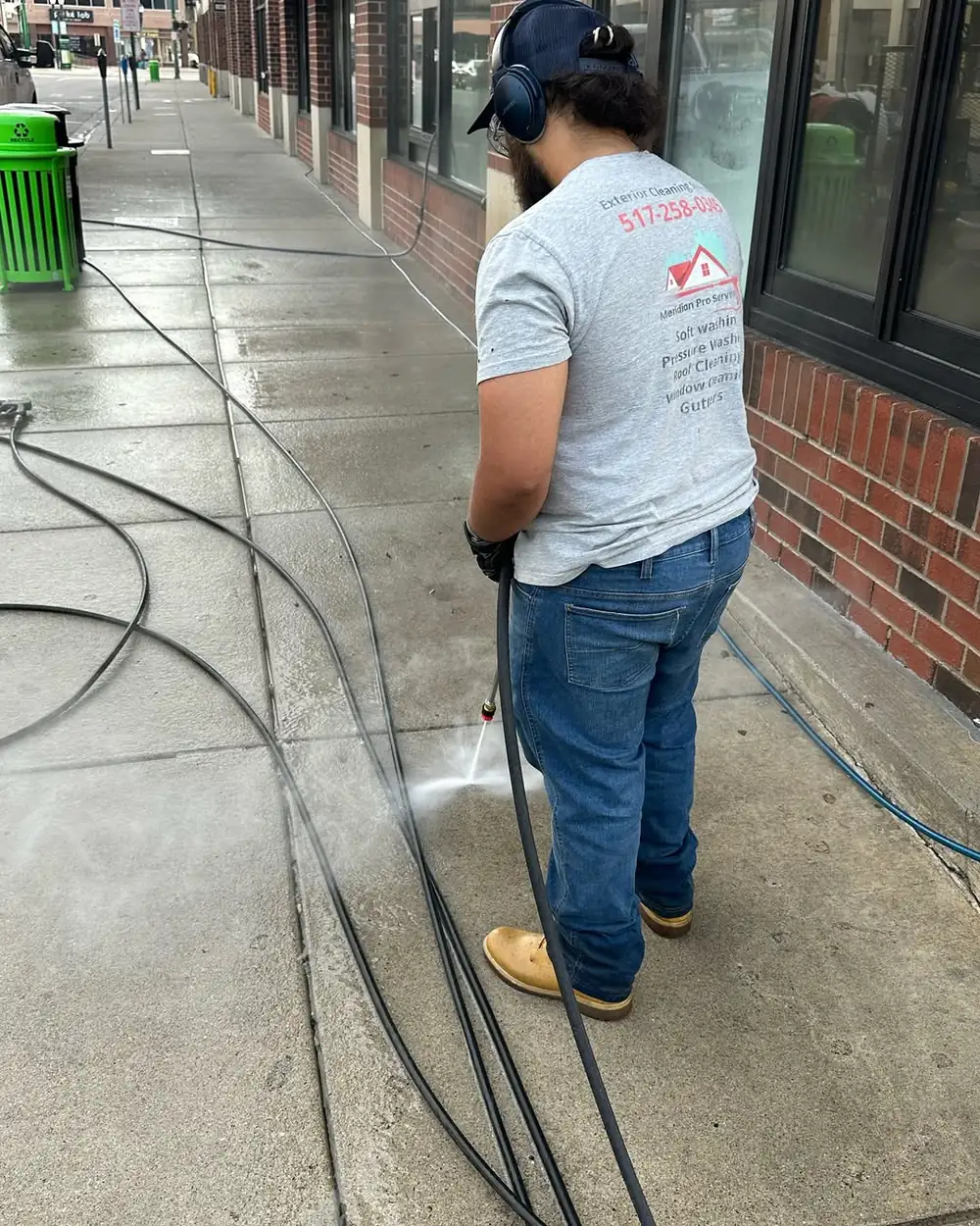 Commercial sidewalk being professionally cleaned for a business near Okemos, MI