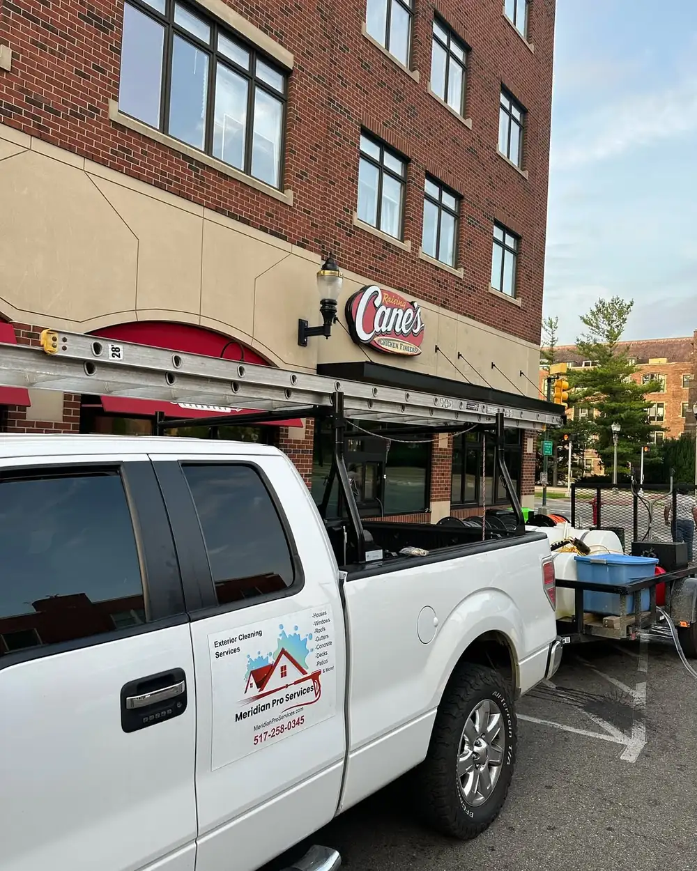 Meridian Pro Services work truck at a commercial pressure washing job in Okemos, MI