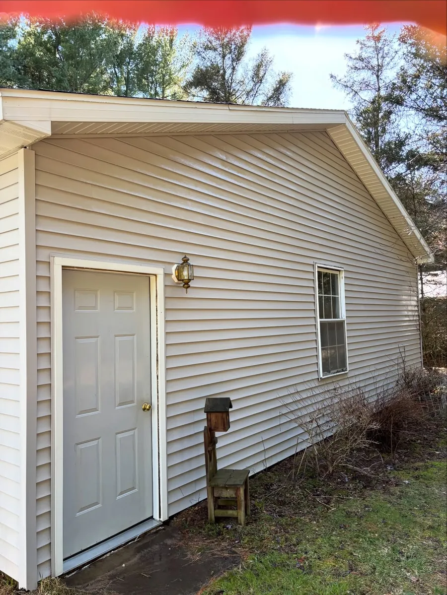 Clean garage siding after soft washing in Okemos, MI