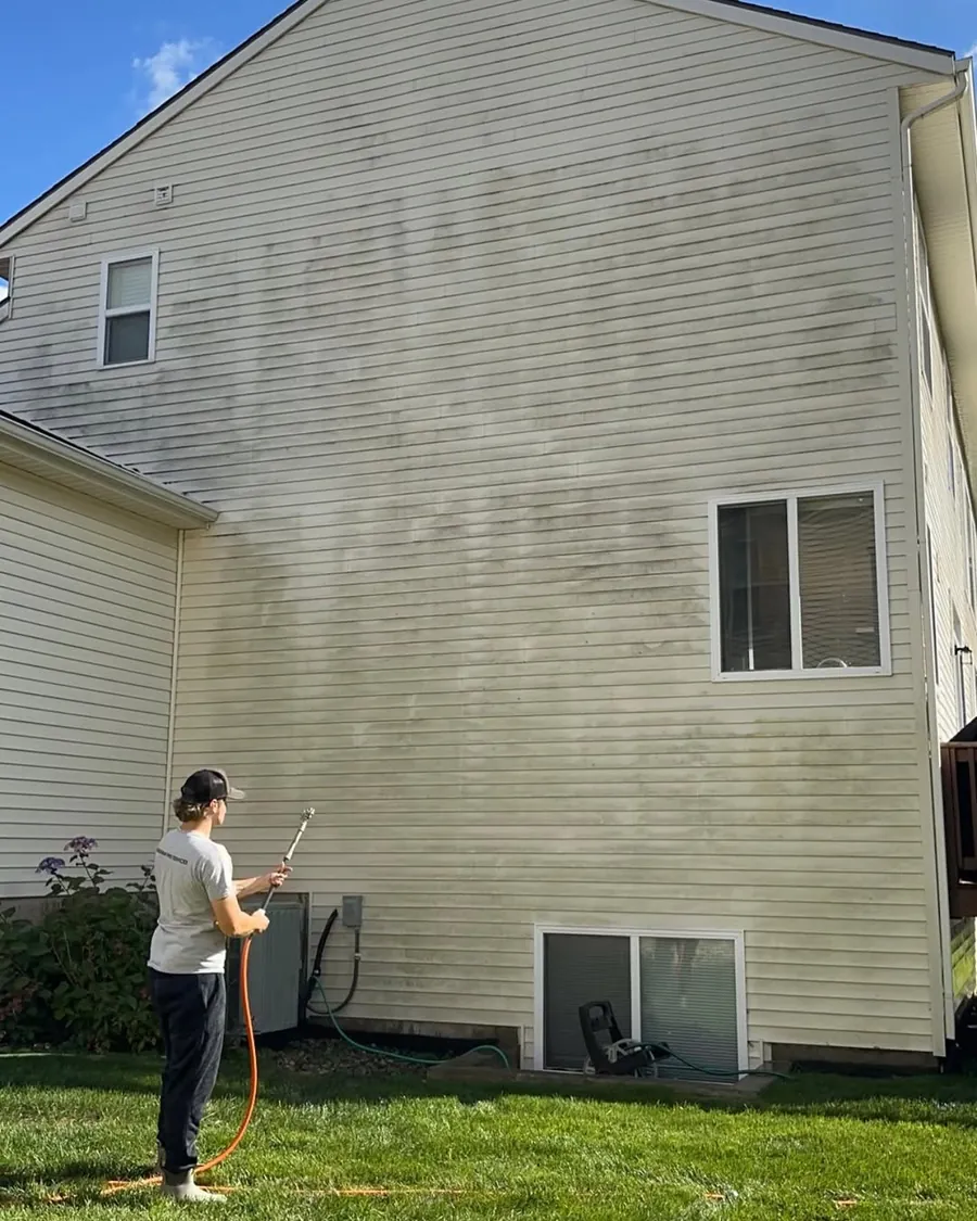 Dirty home siding before professional exterior cleaning in Okemos, MI