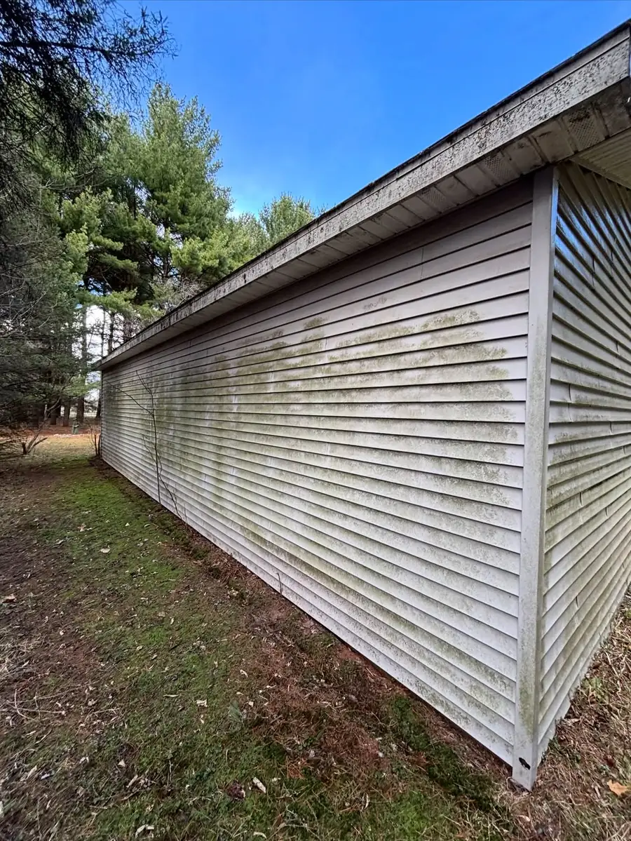 Dirty home siding before professional exterior cleaning in Okemos, MI