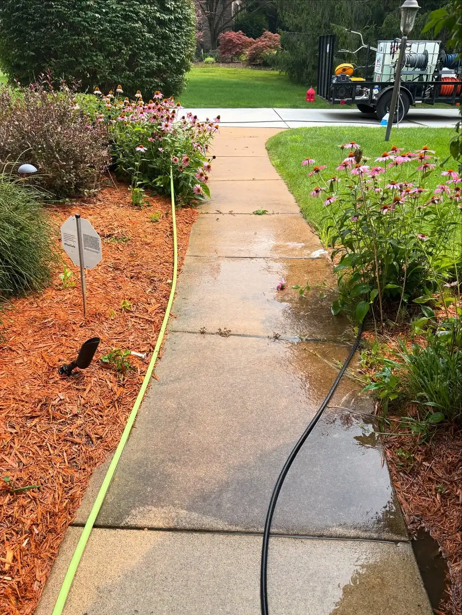 Dirty stained concrete walkway before concrete cleaning in Okemos, MI