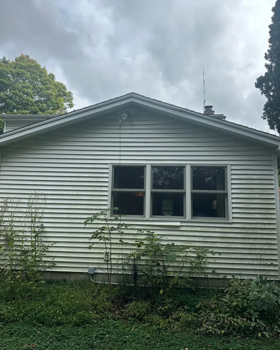 Dirty home siding before professional exterior cleaning in Okemos, MI